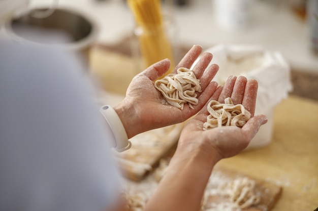 Belle femme prépare de délicieux plats dans sa cuisine à domicile