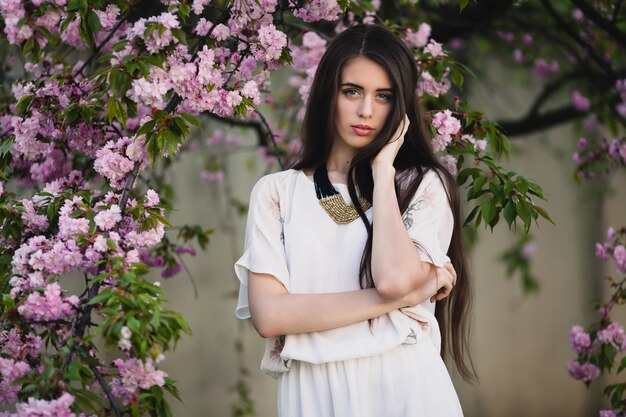 Belle femme près de buisson fleuri