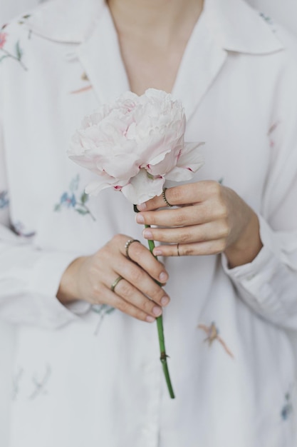 Belle femme sensuelle avec pivoine rose dans les mains Image douce et tendre Esthétique printanière