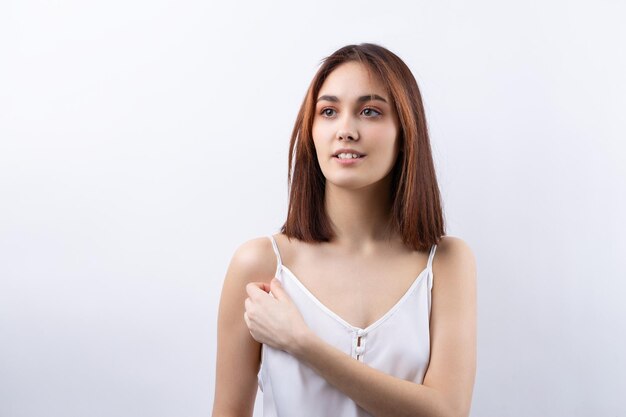 Belle femme souriante avec un maquillage naturel de peau propre et des dents blanches sur fond gris