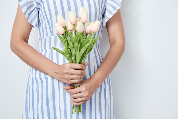 Belle femme tenant un bouquet de tulipes