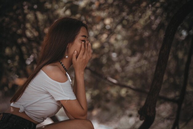 Belle femme thaïlandaise très triste d'un amour non partagé Elle repense et réfléchit à l'amourstyle vintageton sombrecoeur briséfille asiatique