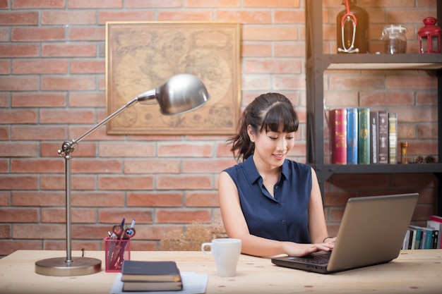 Belle femme travaille dans le bureau à domicile