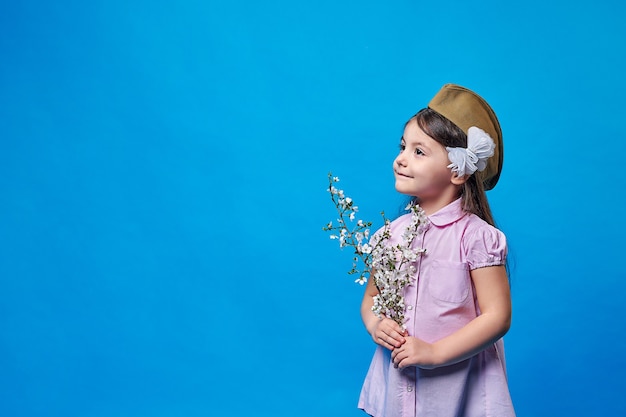 Photo belle fille avec une branche d'un arbre fleuri