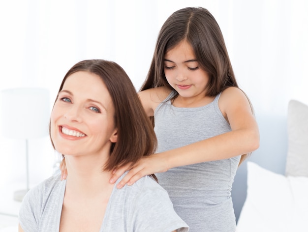 Belle fille brossant ses cheveux de femme à la maison