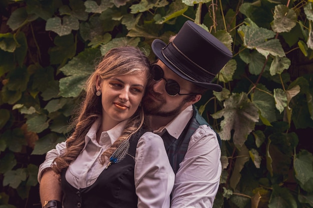 Belle fille avec un couple de gars amoureux dans des vêtements steampunk