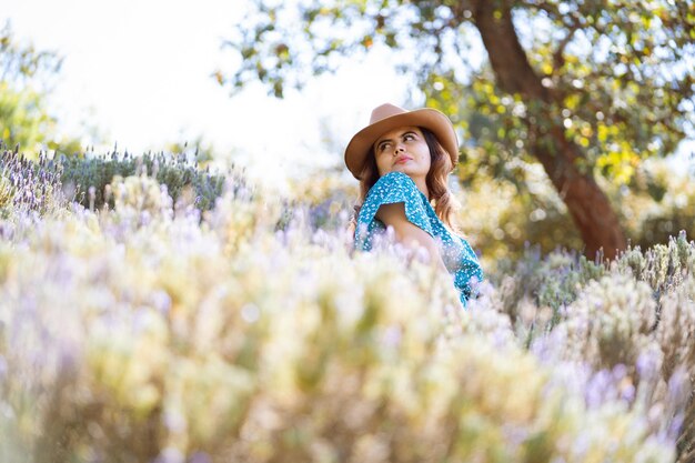 belle fille dans un champ de lavande avec une robe bleue