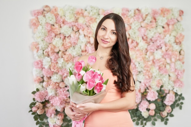 Belle fille avec des fleurs de tulipe.