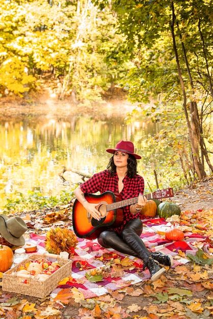 Belle fille avec une guitare sur un fond