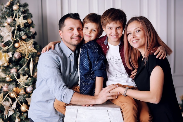 Belle grande famille passe du temps à la maison près de l'arbre de Noël