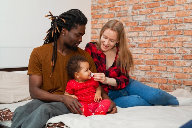 belle jeune famille avec petite fille à la maison