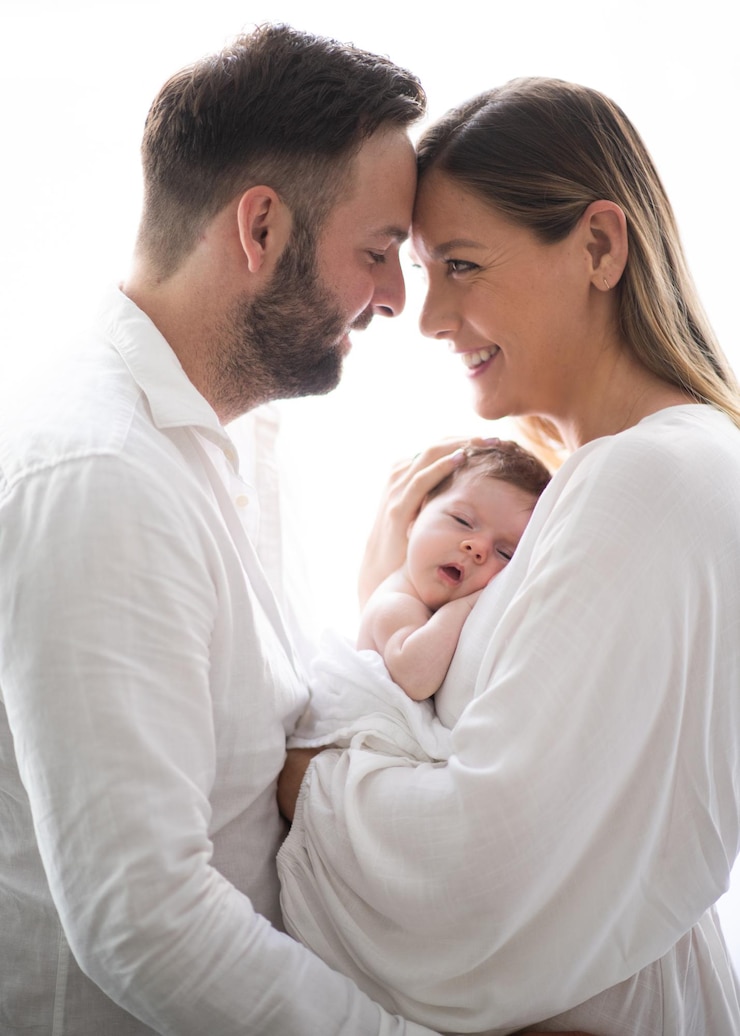 Photo une belle jeune famille souriante, une mère et un père avec leur bébé.