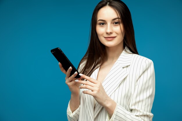 Belle jeune femme à l'aide de téléphone portable