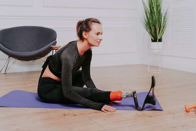 Belle jeune femme avec amputation Jolie et confiante femme avec une jambe handicapée amputée posant contre la honte du corps