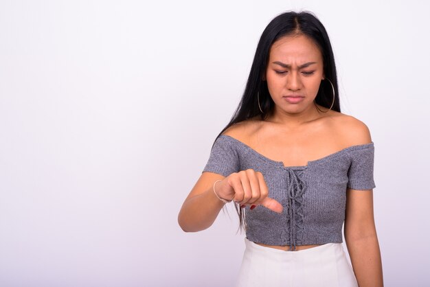 Belle jeune femme asiatique contre le mur blanc