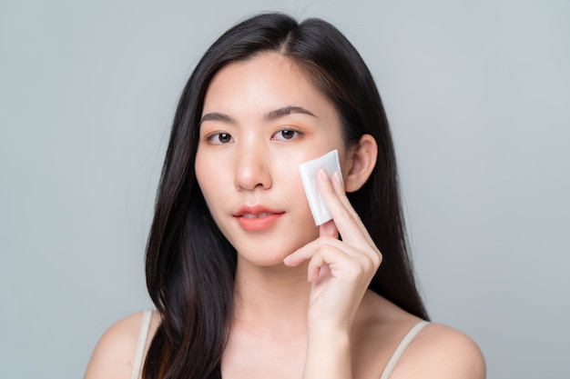 Belle jeune femme asiatique avec une peau fraîche et propre sur fond blanc. Portrait de femmes asiatiques.