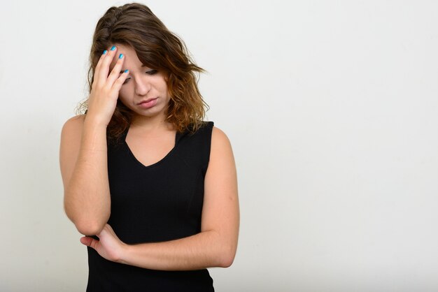 Belle jeune femme aux cheveux bruns contre l'espace blanc