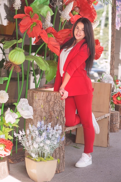 Belle jeune femme brune vêtue d'une veste en tweed classique rouge et d'une chemise blanche