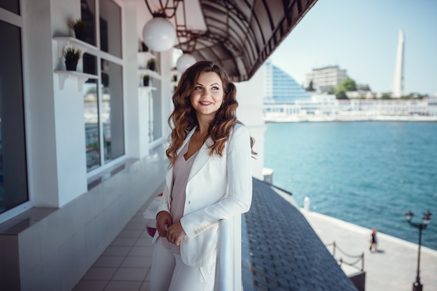 Belle jeune femme sur un café de balcon. En attente d'une réunion d'affaires