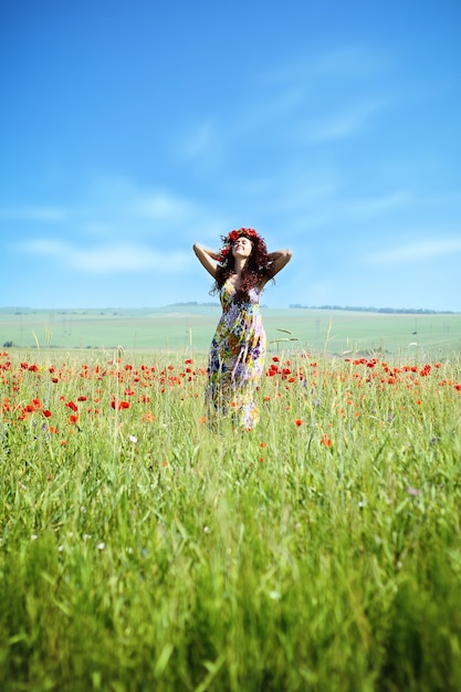 Belle jeune femme dans le champ de pavot