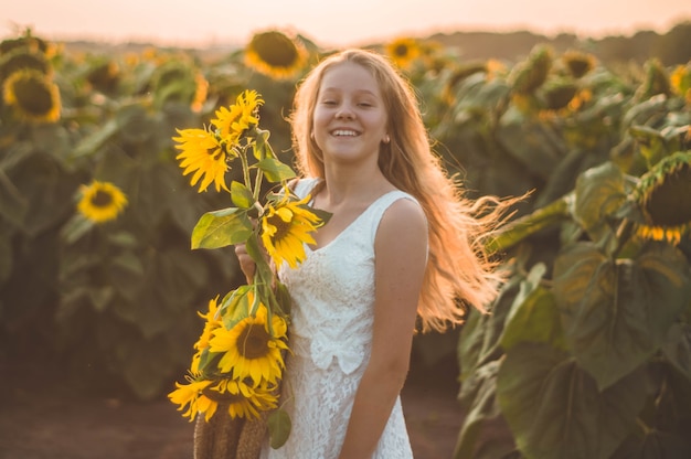 Belle jeune femme dans un champ de tournesol. Portrait d'une jeune femme au soleil. Concept d'allergies au pollen. Bonheur en plein air