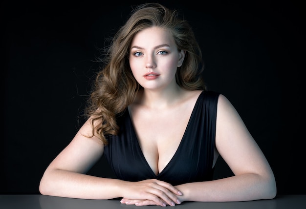 Belle jeune femme avec du maquillage naturel sur mur noir Beauté Soins de la peau Modèle de grande taille