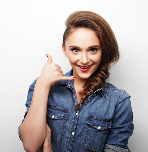 Belle jeune femme portant des vêtements décontractés posant sur fond blanc