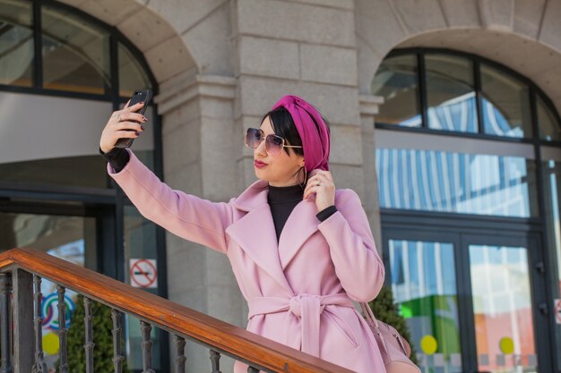 Belle jeune femme en promenade avec un téléphone