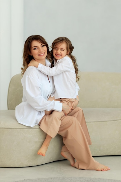 Belle jeune femme et son adorable petite fille étreignant et souriant