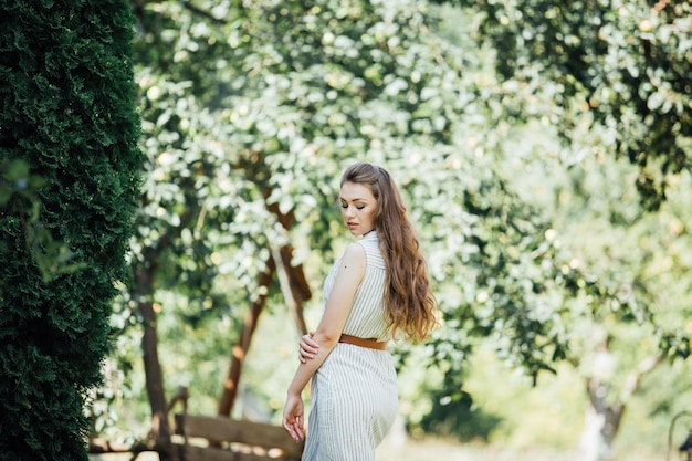 Une belle jeune femme souriante à l'extérieur.