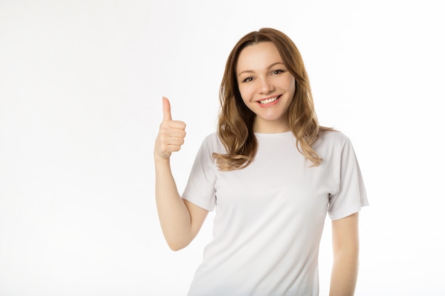 Belle jeune femme en t-shirt blanc avec le geste de la main