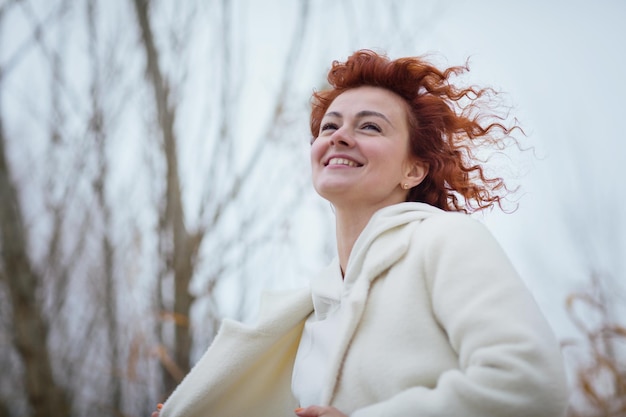 Belle jeune femme en vêtements blancs à la mode pose en mouvement