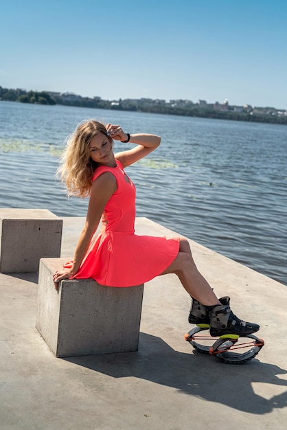 Belle jeune fille entraîneur de fitness avec saut vêtue de chaussures spéciales reposant au bord du lac