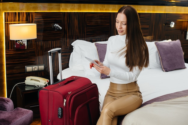 Une belle jeune fille est entrée dans sa chambre dans un hôtel de luxe. Tourisme et loisirs.