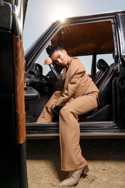 Belle lena sur la direction de la voiture et regardant la caméra Photo de haute qualité