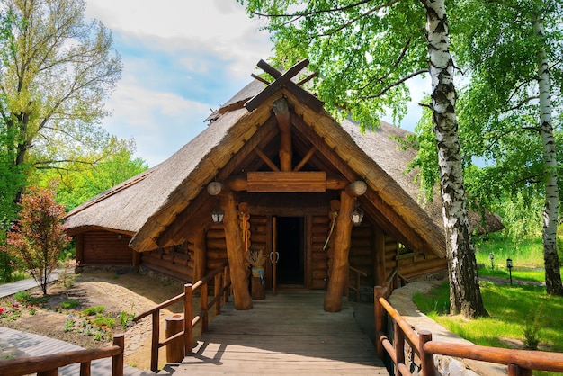 Belle maison en rondins dans un parc verdoyant le jour d'été