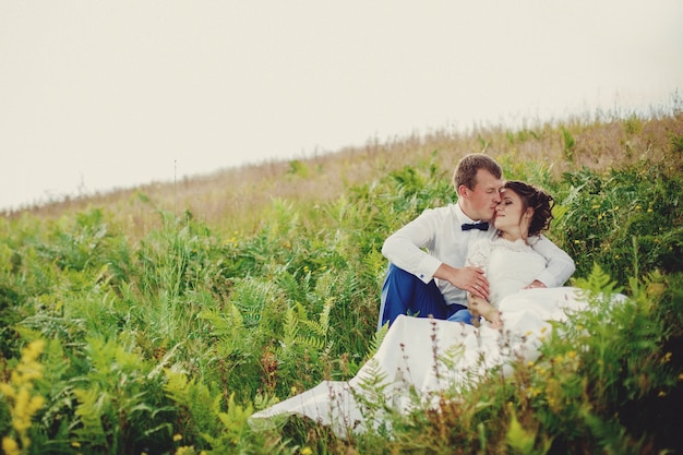 Belle mariée et le marié posant dans la nature