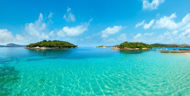 Belle mer Ionienne avec de l'eau turquoise claire et vue sur la côte d'été du matin depuis la plage Ksamil Albanie panorama de points multi-coups