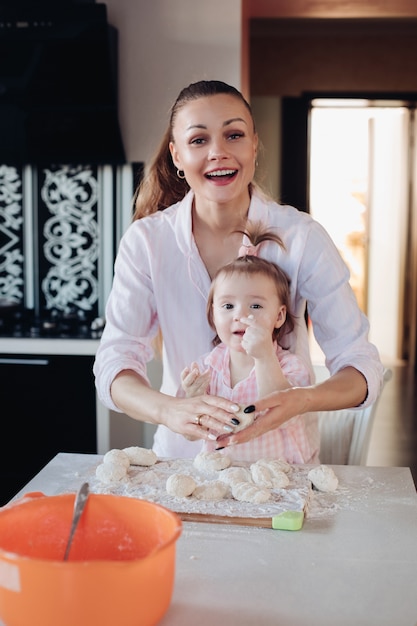 Belle mère aimante et jolie fille cuisiner ensemble dans la cuisine