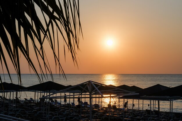 Photo belle plage de lever de soleil au coucher du soleil avec ciel rose et jetée. concept de voyage, de détente et de méditation