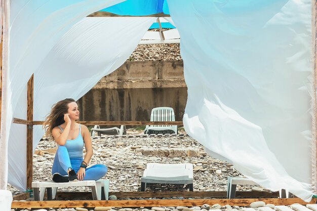 belle sportive après remise en forme se repose dans le belvédère au bord de la mer