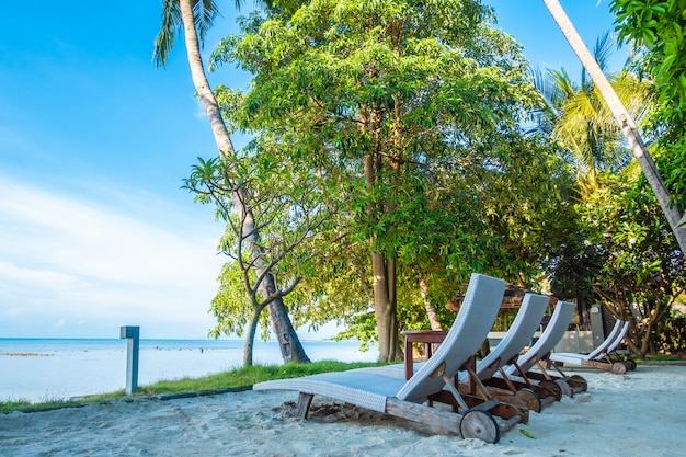 Belle vue extérieure avec parasol et une chaise sur la plage et la mer