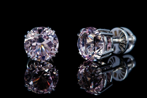 Belles boucles d'oreilles en or avec des pierres précieuses de morganite sur fond noir