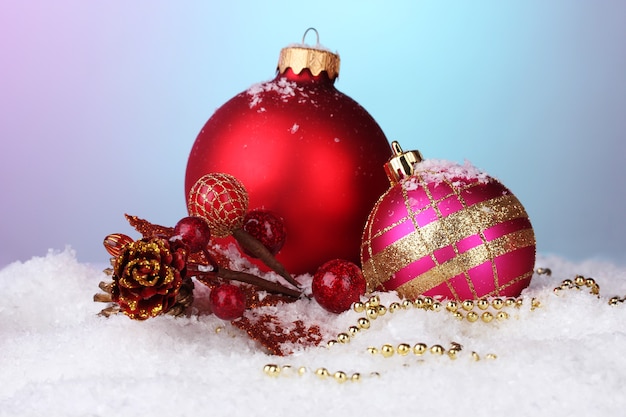 Belles boules de Noël et cône sur la neige sur fond clair