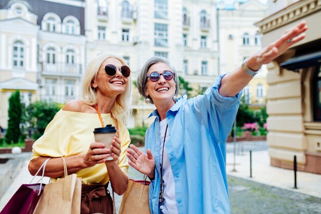 Belles femmes âgées heureuses faisant du shopping dans le centre-ville