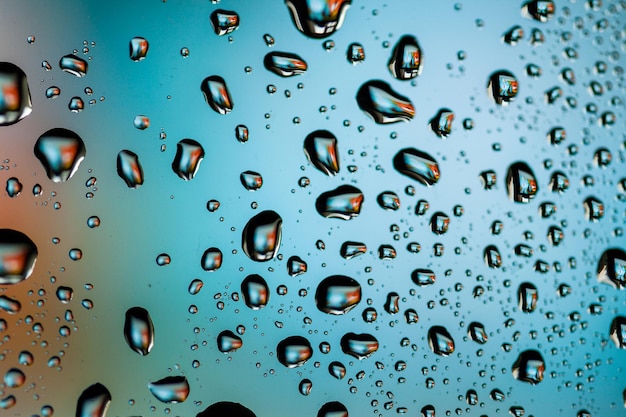 Belles gouttelettes d'eau multicolores sur un verre