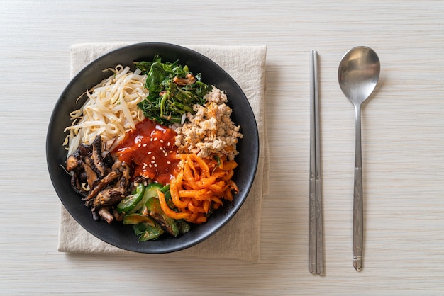 Bibimbap, salade épicée coréenne avec bol de riz - style cuisine traditionnelle coréenne