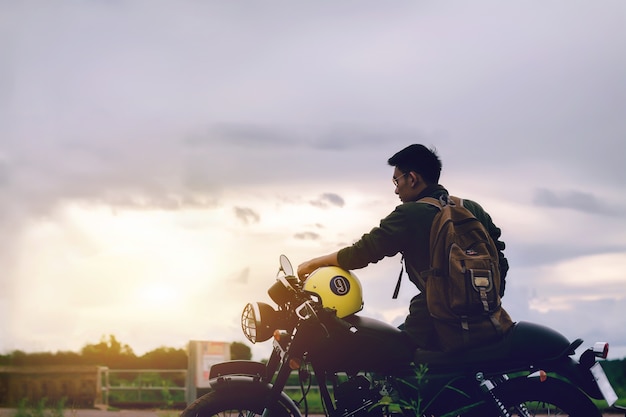 Biker man et moto avec fond de rivière.