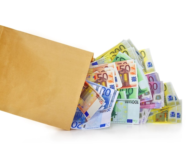 Billets en euros sortant d'un sac en papier sur fond blanc