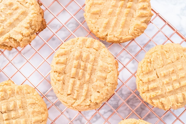 Biscuits au beurre d'arachide fraîchement cuits refroidissant sur une grille de séchage.